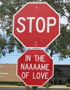 stop sign with second sign saying in the naaaame of love