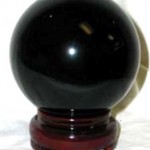 image of black ball on brown pedistle